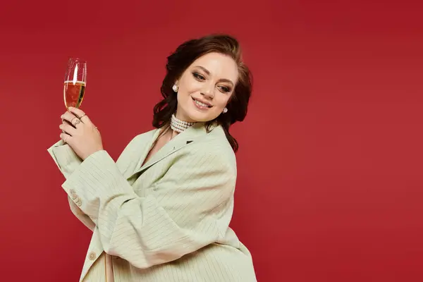 Joy and elegance radiate as a lovely woman toasts with champagne, dressed to impress. — Stock Photo