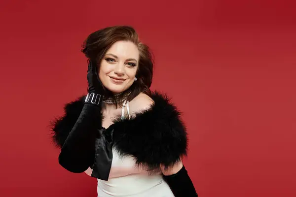 A young beautiful woman showcases elegance with stylish attire and dramatic accessories. — Stock Photo