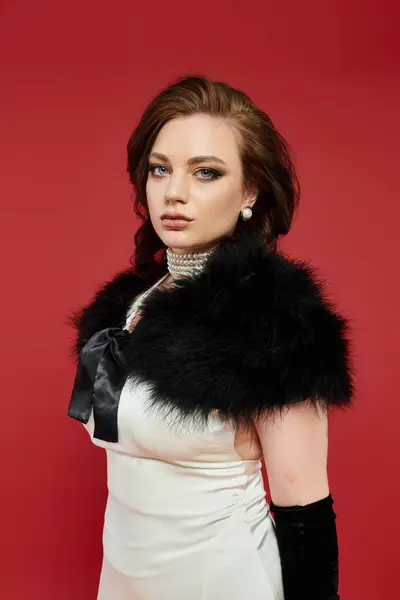 A stunning woman showcases her elegance with a sophisticated outfit and captivating expression. — Stock Photo