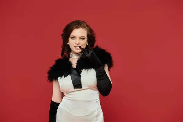 The young woman showcases elegance with a striking outfit and a captivating expression. — Stock Photo