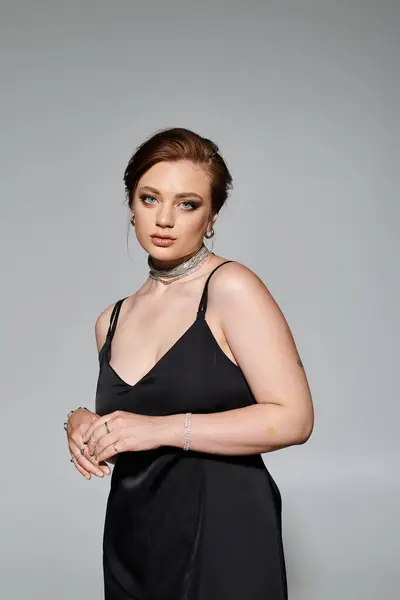 A confident young woman commands attention in her elegant outfit, showcasing grace and poise. — Stock Photo