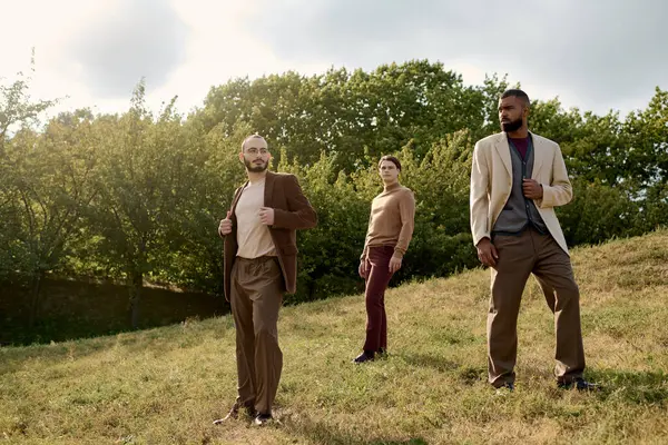 Three handsome men exhibit their fashionable autumn attire while enjoying a serene outdoor setting. — Stock Photo