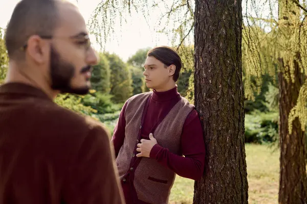Handsome gentlemen showcase autumn fashion amid golden foliage and tranquil nature, exuding confidence and style. — Stock Photo