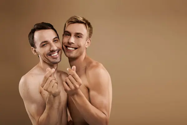 Two young men express their love with playful gestures, surrounded by a calming environment. — Stock Photo