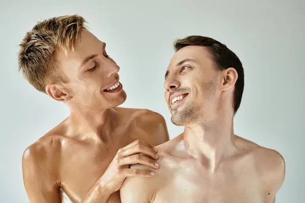 Two young men express love and happiness in a cozy, warm atmosphere, showcasing their bond. — Stock Photo