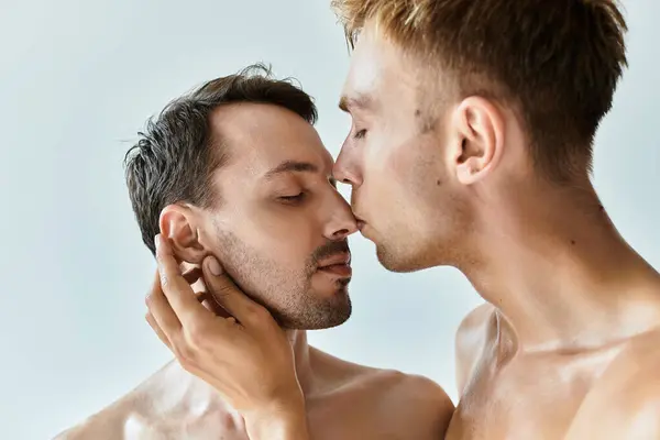 Two young men embrace each other intimately, lips almost touching, radiating love and affection. — Stock Photo