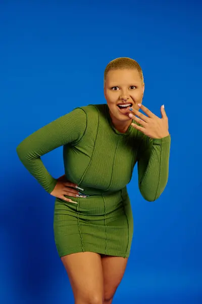 A stylish young woman playfully shows off her unique, vibrant fashion sense. — Stock Photo