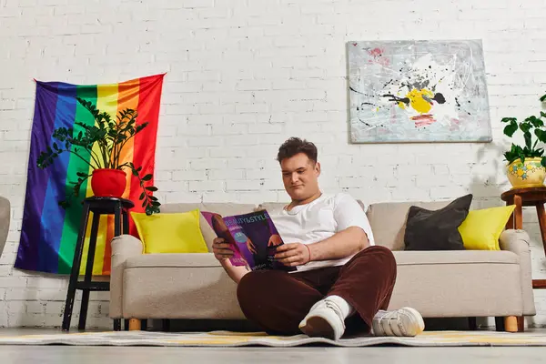 A unique individual relaxes on the floor while reading a magazine, surrounded by colorful decor. — Stock Photo