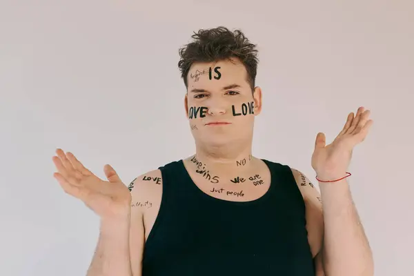 A queer person expresses love and unity with artistic body markings in a bright setting. — Stock Photo