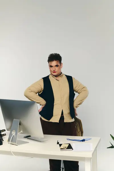 With hands on hips, a queer individual exudes confidence in a stylish office environment. — Stock Photo