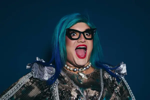 With bright blue hair and playful attire, an individual showcases their confidence and style — Stock Photo