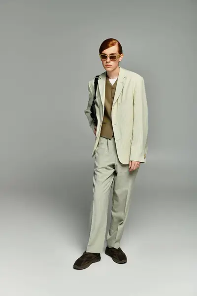 A teenage boy with striking red hair poses elegantly in a smart casual ensemble, exuding confidence and style. — Stock Photo