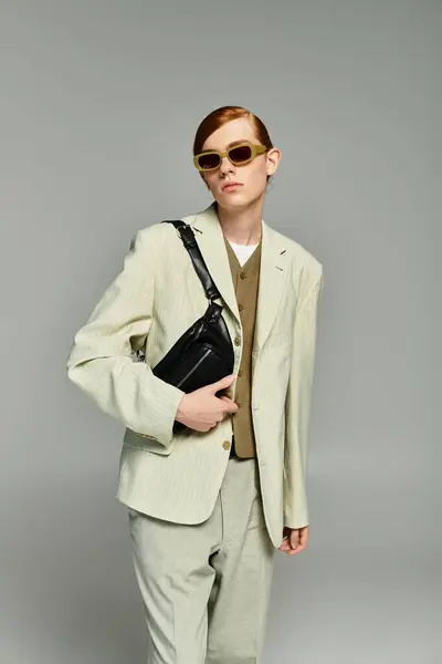 A teenage boy with striking red hair showcases an elegant smart casual outfit in a sleek grey studio. — Stock Photo