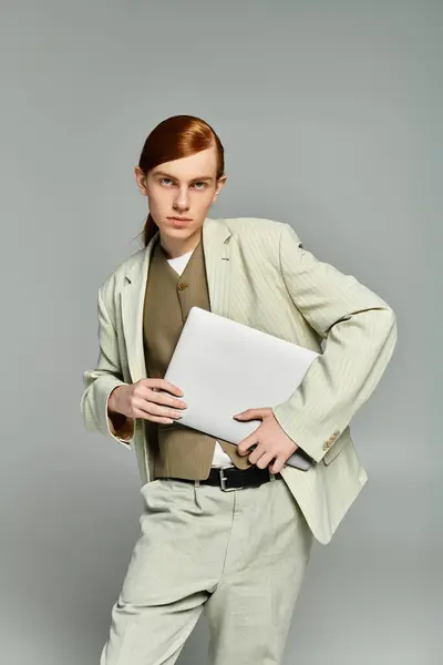 A stylish teenage boy with red hair poses confidently in an elegant outfit, showcasing a modern aesthetic. — Stock Photo