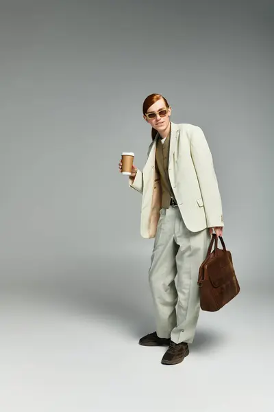 Sporting an elegant smart casual outfit, a red-haired teenager poses confidently in a grey studio. — Stock Photo