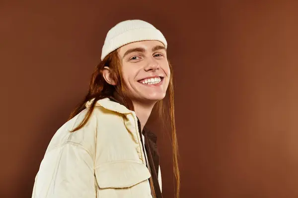 A cheerful teenage boy with red hair showcases his fashion sense while posing confidently in the studio. — Stock Photo