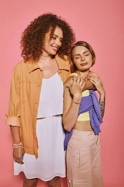 A joyful lgbt couple with natural makeup expresses their love in a bright studio setting. — Stock Photo