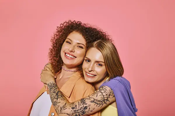 A joyful lgbt couple showcases their love and connection against a vibrant pink backdrop. — Stock Photo
