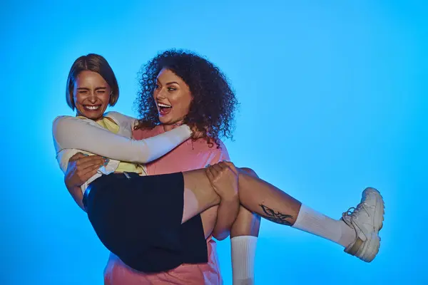 A joyful lgbt couple showcases their love against a vibrant pink backdrop, radiating happiness. — Stock Photo