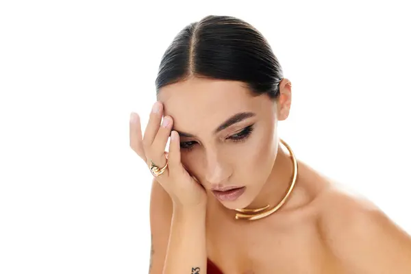 This captivating young woman expresses deep contemplation while adorned with striking accessories. — Stock Photo