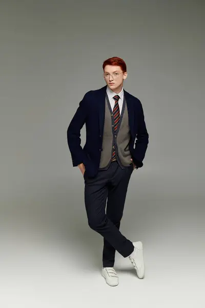 A young student showcases a trendy layered winter outfit with flair in a modern studio setting. — Stock Photo