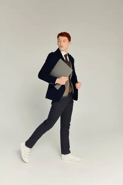 A young man with striking red hair presents an elegant winter outfit, balancing style and sophistication. — Stock Photo