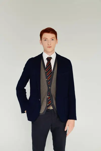 A young man with striking red hair showcases a sophisticated winter outfit, radiating style and confidence. — Stock Photo