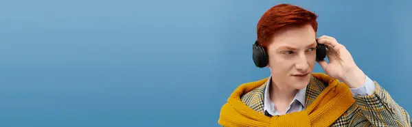 A young student with vibrant red hair showcases elegant winter fashion in a cozy studio. — Stock Photo