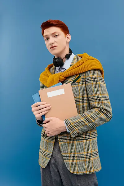 A confident young student in a chic layered outfit stands in a studio, exuding fashion-forward elegance. — Stock Photo