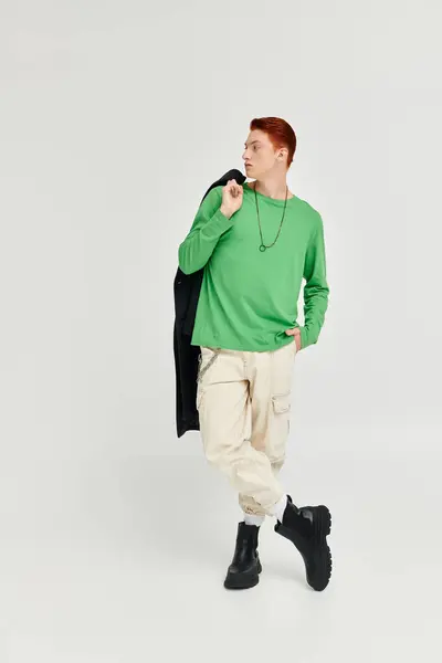 A young man with striking red hair models in a chic studio, exuding style and confidence. — Stock Photo