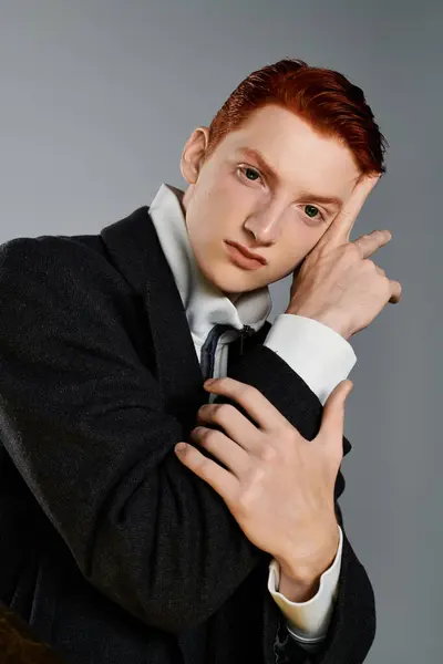 A confident young man with striking red hair showcases winter fashion while striking a contemplative pose. — Stock Photo
