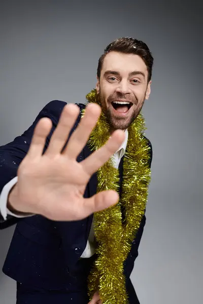 A handsome young man wearing festive attire and smiling brightly while celebrating joyfully. — Stock Photo