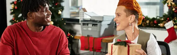 Excited coworkers share joy as they exchange gifts while celebrating Christmas in the office. — Stock Photo