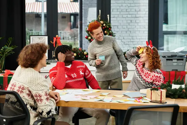 Coworkers delight in holiday cheer while celebrating Christmas with laughter and games. — Stock Photo