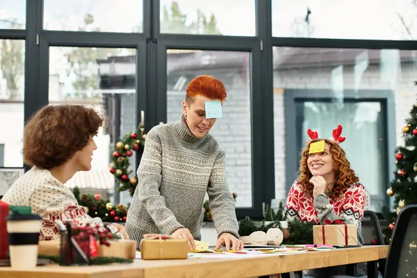 Coworkers joyfully celebrate Christmas with games and decorations in their office. — Stock Photo