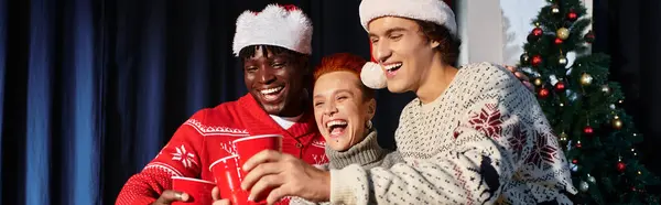 Coworkers celebrate Christmas together, sharing laughter and festive drinks in the office. — Stock Photo
