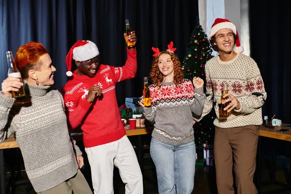 A group of young coworkers enjoys a cheerful Christmas celebration in the office. — Stock Photo