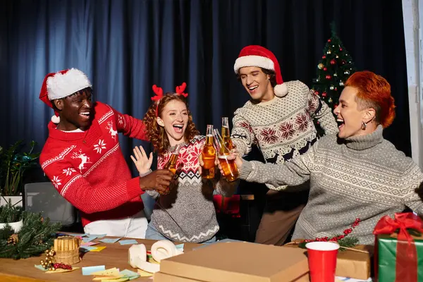 Festive coworkers laugh and toast with drinks, embracing the joyful spirit of Christmas together. — Stock Photo