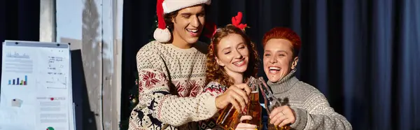 Coworkers enjoy a cheerful Christmas celebration with drinks and laughter in the office. — Stock Photo
