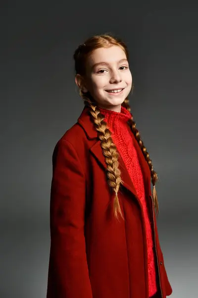 A cheerful young girl smiles brightly while wearing warm winter clothing, showcasing a cozy vibe. — Stock Photo