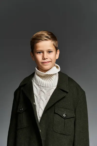 The joyful boy wearing a warm sweater smiles warmly, embodying winter charm effortlessly. — Stock Photo