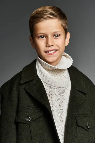 A cheerful boy showcases a cozy winter outfit with a playful smile and gentle demeanor — Stock Photo