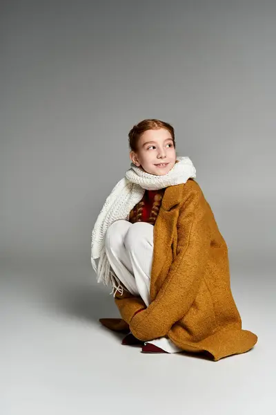 A girl bundles up in a warm coat and scarf while radiating joy on a frosty winter day. — Stock Photo