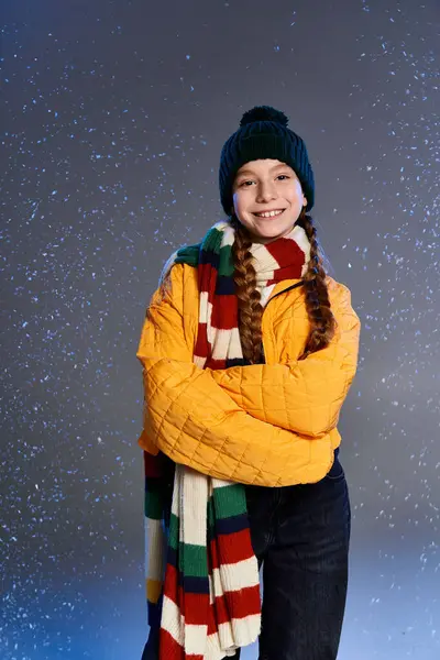 A young girl smiles warmly while dressed in colorful winter layers, embracing the cozy season. — Stock Photo