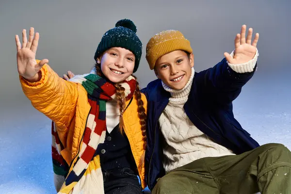 Two cheerful kids in cozy winter clothes enjoy their time together, radiating happiness. — Stock Photo