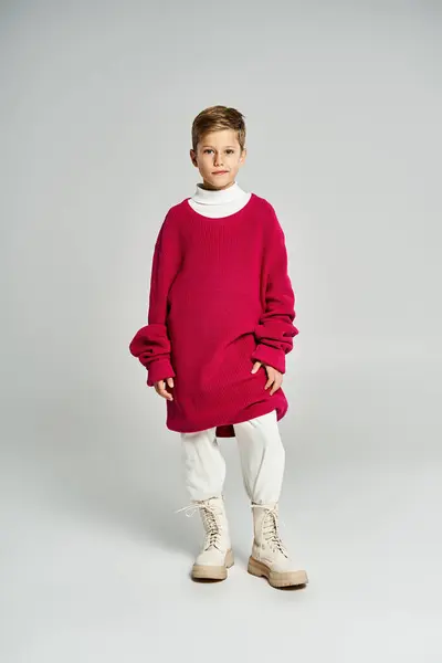 A young boy stands proudly, dressed in winter clothing that combines comfort and style. — Stock Photo