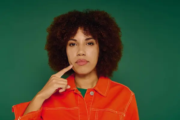 A pretty young African American woman with curly hair showcases her deep contemplation in casual attire. — Stock Photo