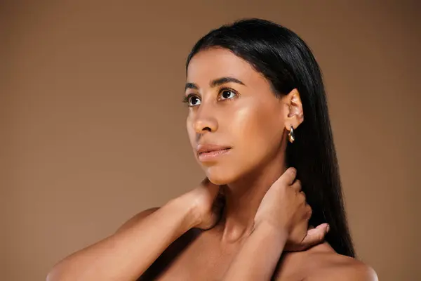 A stunning African American woman demonstrates beauty in a bright studio. — Stock Photo