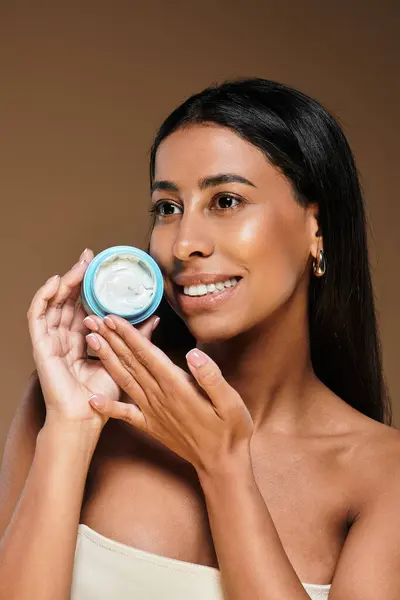 A stunning African American woman highlights her skincare routine in a studio setting. — Stock Photo