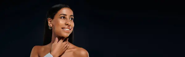 African American woman with brunette hair demonstrates beauty in studio environment. — Stock Photo